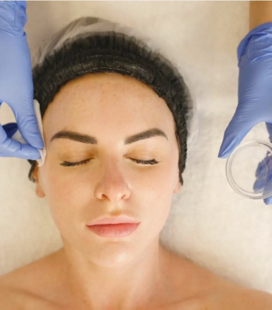 Step two of the Illumifacial: the Tri-Fruit acid peel being applied